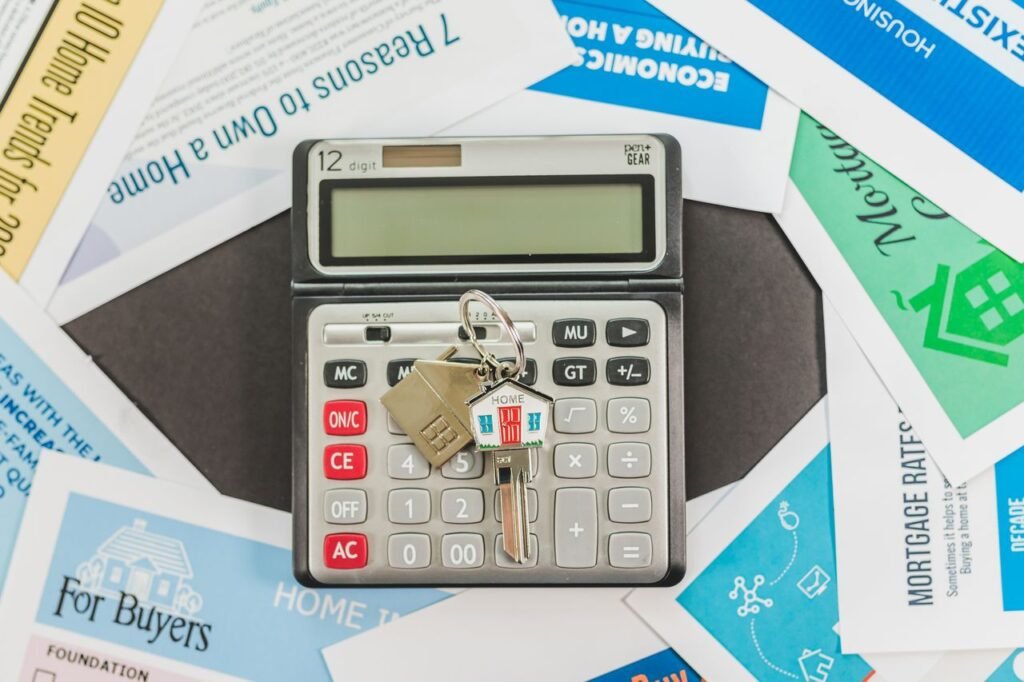 What's Next for Mortgage Rates? A Look at Key Factors Calculator with keys and real estate documents symbolizes home buying finances.