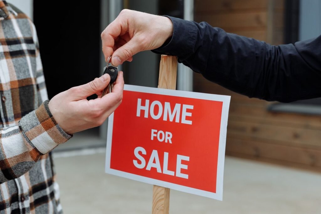 Santa Clarita Is Getting a Major Glow-Up — And It's Changing What Buyers Are Looking For Close-up of a home for sale sign with people exchanging keys.