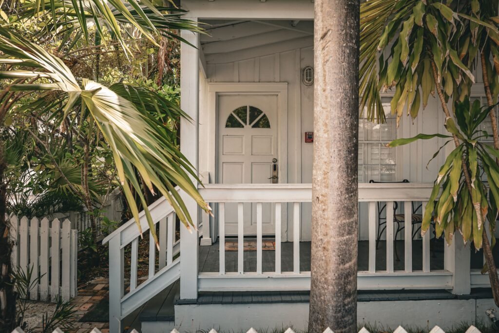 Santa Clarita Housing Market Update: November 2026 Charming tropical front porch with palm trees and white wooden railing, evoking a summer vibe.