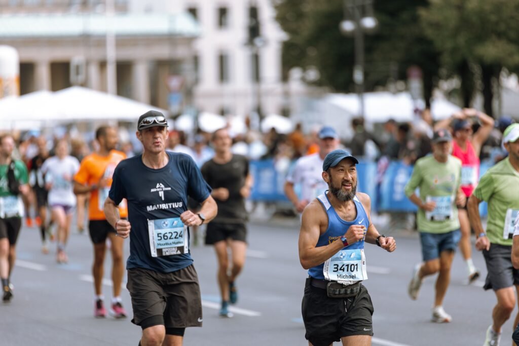 Santa Clarita Turkey Trots 2026 (Plus a Fall Hike Worth Taking) Focused runners competing in a vibrant city marathon event, showcasing athletic determination.